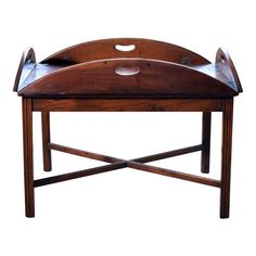 a wooden bench with an oval shaped top and two curved legs on one end, sitting against a white background