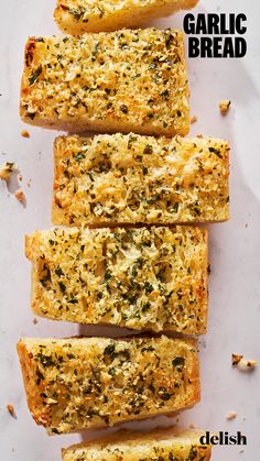 garlic bread cut into four pieces on a white surface