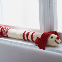 a stuffed animal is sitting on the window sill