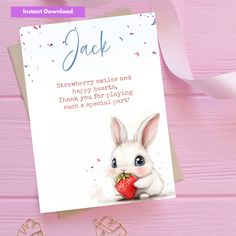 a greeting card with an image of a bunny holding a strawberry