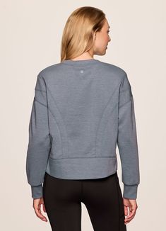 Our In The Studio Cropped Pullover combines a classic crewneck design and super soft, trendy scuba fabric for a lightweight pullover you can take from studio to street. A slightly cropped length is complemented by a relaxed fit, dropped shoulders and sporty seaming detail that allow for easy styling and layering. Throw this cute crop sweatshirt over a sports bra for a workout or pair it with jeans for a casual-cute look. Versatile Crew Neck Tops With Ribbed Cuffs, Versatile Long Sleeve Sweatshirt With Ribbed Cuffs, Sporty Tops With Ribbed Waistband For Layering, Versatile Crew Neck Sweatshirt For Layering, Stretch Crew Neck Sweatshirt With Ribbed Waistband, Stretch Sweatshirt With Ribbed Waistband And Crew Neck, Sportswear Top With Ribbed Waistband And Crew Neck, Sportswear Crew Neck Top With Ribbed Waistband, Sportswear Top With Crew Neck And Ribbed Waistband