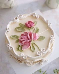 a white cake with pink flowers on it