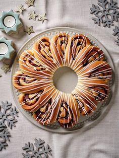 a bundt cake with frosting and chocolate drizzled on top, surrounded by snowflakes