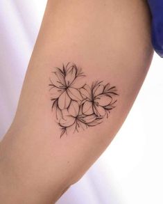 a black and white photo of a flower tattoo