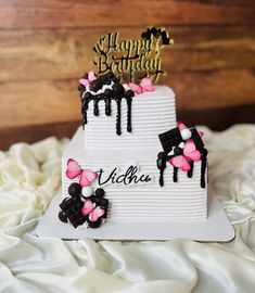 a birthday cake with pink and black decorations