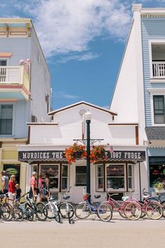 many bicycles are parked in front of the shops