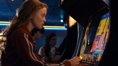 a woman playing a video game in a casino