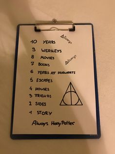 a clipboard with harry potter's movies written on it that says 10 years