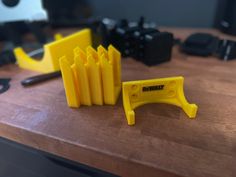 some yellow plastic objects sitting on top of a wooden table