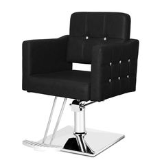 a black chair sitting on top of a metal base with studded trimmings