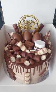 a birthday cake with chocolate and marshmallows in a box