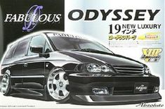 an advertisement for a new luxury car from the 1990s's, featuring a black van with white rims