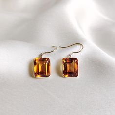 These stunning earrings are set in 14K Solid Yellow Gold with Natural Madeira Citrine with utmost precision. It is an unique gemstone earring pair for nearly every occasion and is completely hassle-free jewelry. 🔷ABOUT GEMSTONE: Citrine, with its vibrant golden-yellow hues, is a gem of joy and abundance, radiating the warmth and energy of the sun. This captivating stone embodies qualities of positivity, success, and prosperity, believed to infuse one's life with a sunny disposition and enthusia Formal Topaz Earrings, Rectangular Gemstone Earrings For Anniversary, 14k Yellow Gold Gemstone Earrings, Classic Faceted Wedding Earrings, Classic Wedding Faceted Earrings, Formal Yellow Gold Topaz Earrings, Fine Jewelry Yellow Gold Gemstone Earrings, Yellow Gold Gemstone Earrings Fine Jewelry, Elegant Formal Citrine Earrings