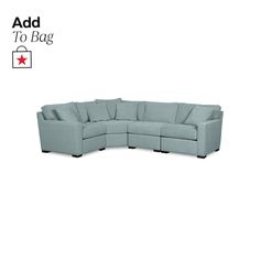 a blue sectional couch sitting on top of a white floor next to a red star