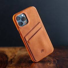 an iphone case sitting on top of a wooden table