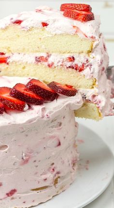 there is a cake with strawberries on it and one slice cut from the cake