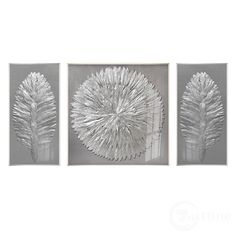 three metal artwork pieces hanging on a wall