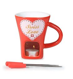 a red coffee cup with a candle in it