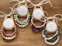 six little old soul bracelets with tags on them sitting on a wooden table next to each other