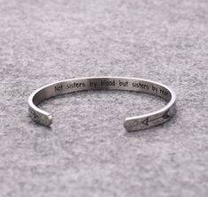 Sisters Jewelry, Not sisters by blood but sisters By Heart, Sisters Cuff, Sister Gift, Sister Bracelet, Sister Jewelry, Friendship Bracelet This is the perfect cuff for the special friend in your life.   Not sisters by blood but sisters By Heart, stamped on the inside of the cuff with a double heart stamped on the front sides. Details: Stainless Steel Size: 6mm width, 62mm inner diameter, 32mm opening Your order will be conveniently sent packaged in pretty organza bag with sentiment card.  If th Silver Friendship Bracelets, Soul Sisters Gifts, Heart Bangle Bracelet, Sister Bracelet, Sisters By Heart, Sister Jewelry, Best Stocking Stuffers, Friendship Jewelry, Inspirational Bracelets