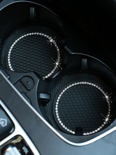 two speakers in the center console of a car with diamond trimmings on them