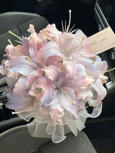 a bouquet of pink flowers sitting on top of a car seat