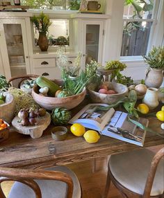 a wooden table topped with lots of different types of fruit and vegtables