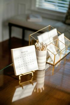 a desk with a calendar and pen holder on it