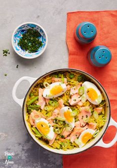 a pot filled with rice and eggs on top of a table