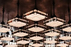 an image of many square lights hanging from the ceiling with mirrors on each one side