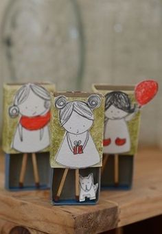 three small vases sitting on top of a wooden table