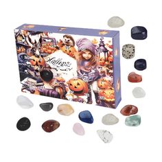 a box filled with lots of different colored rocks next to a white cat wearing a hat