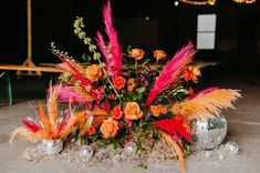 an arrangement of flowers and disco balls on the ground