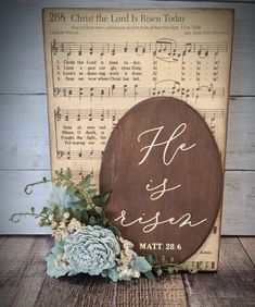 a wooden sign that says he is risen and has flowers on the side with music notes