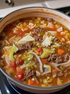 a bowl of soup sitting on top of a stove