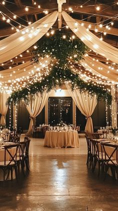 an indoor wedding venue with lights and draping