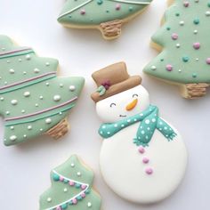 decorated cookies in the shape of christmas trees and snowmen