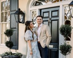 a man and woman standing in front of a door