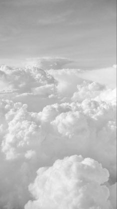 black and white photograph of clouds taken from an airplane