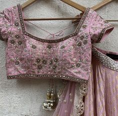 A three-piece nude pink lehenga set from the Priti Sahni collection. This georgette nude pink butti lehenga with gota work detail is paired with a dull gold blouse with bead and zardozi hand work embroidery. This outfit is completed with a nude pink dupatta in net material with sequin work. Elegant Pink Lehenga With Gota Work, Elegant Pink Dola Silk Choli, Elegant Pink Choli With Mirror Work, Navratri Pink Embellished Blouse Piece, Navratri Embellished Pink Blouse Piece, Pink Embellished Blouse Piece For Navratri, Pink Embellished Blouse For Navratri, Pink Embellished Dola Silk Dupatta, Embellished Pink Dola Silk Dupatta