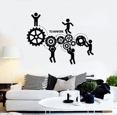 a living room with a white couch and black wall decal on it's side