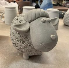 a ceramic sheep sitting on top of a table