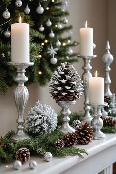 a mantle with candles, pine cones and christmas decorations on it in front of a christmas tree