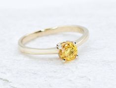 CERTIFIED Sapphire Ring set with a Natural Yellow Sapphire in a flawless diamond cut & yellow color, 0.65 Carats, 5mm round. The ring weighs 2.02 Grams of Solid 18k Gold. Premium Fine Jewellery ☞ made to last. Details: * Natural Yellow Sapphire: size 5mm, 0.65 Carat (CERTIFIED!) * Band Width 1.4 millimetres * Band Thickness 1.2 millimetres * Solid 18k White Gold ☞ 750 Hallmark * GUARANTEE on materials - GIL Certificate included ♕ * Premium Ring box included  *Sizes 12-16 U.S. need to be custom m Yellow Brilliant Cut Diamond Ring, Yellow Gold Topaz Ring With Yellow Sapphire Center Stone, Yellow Sapphire Ring With Center Stone In Yellow Gold, Fine Jewelry Yellow Diamond Cut Ring, 14k Gold Yellow Sapphire Ring, Fine Jewelry Yellow Diamond Ring With Center Stone, Oval Yellow Diamond Promise Ring, Yellow Gold Ring With Yellow Sapphire Center Stone, White Gold Rings With Brilliant Cut Yellow Sapphire