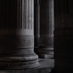 the columns are all lined up together in black and white photo with light coming through them