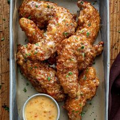 chicken wings and dipping sauce on a tray