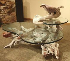 a glass coffee table with driftwood on top