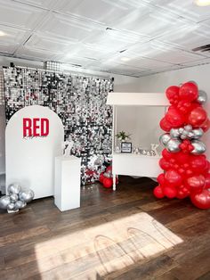 a room with red balloons and white furniture