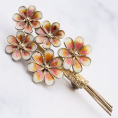 This vintage Italian gilt .800 silver filigree pique a jour brooch showcases a beautiful flower bouquet. Each flower painted in a pink, orange and white enamel gradient. This brooch weighs 6.6 grams and measures 54mm in length. It is in great vintage condition with light wear and is marked as shown. Elegant Flower Enamel Pin Collectible, Spring Gold Brooch Jewelry, Spring Season Gold Brooch Jewelry, Spring Gold Jewelry Brooch, Gold Brooch Jewelry For Spring, Pink Flower Enamel Brooch, Gold Brooches For Spring Gift, Spring Flower Enamel Pin Gift, Spring Flower Enamel Pin For Gift