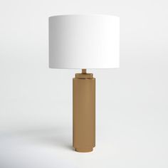 a gold lamp with a white shade on it's base and a light bulb in the shape of a rectangle